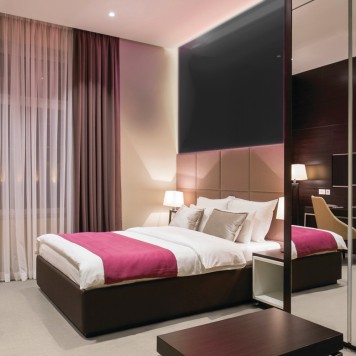 Réalisation tête de lit chambre d'hôtel avec panneau mural décoratif brillant noir "Liquorice" Altro Whiterock Chameleon